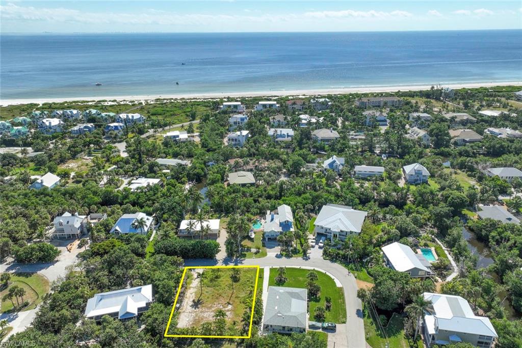 Aerial view of property's location featuring nearby suburban area and property parcel outlined