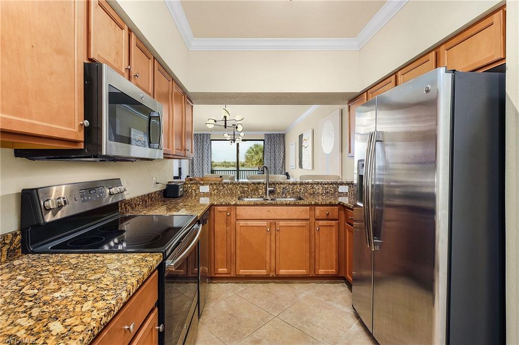 Modern kitchen with granite tops overlooking living area.