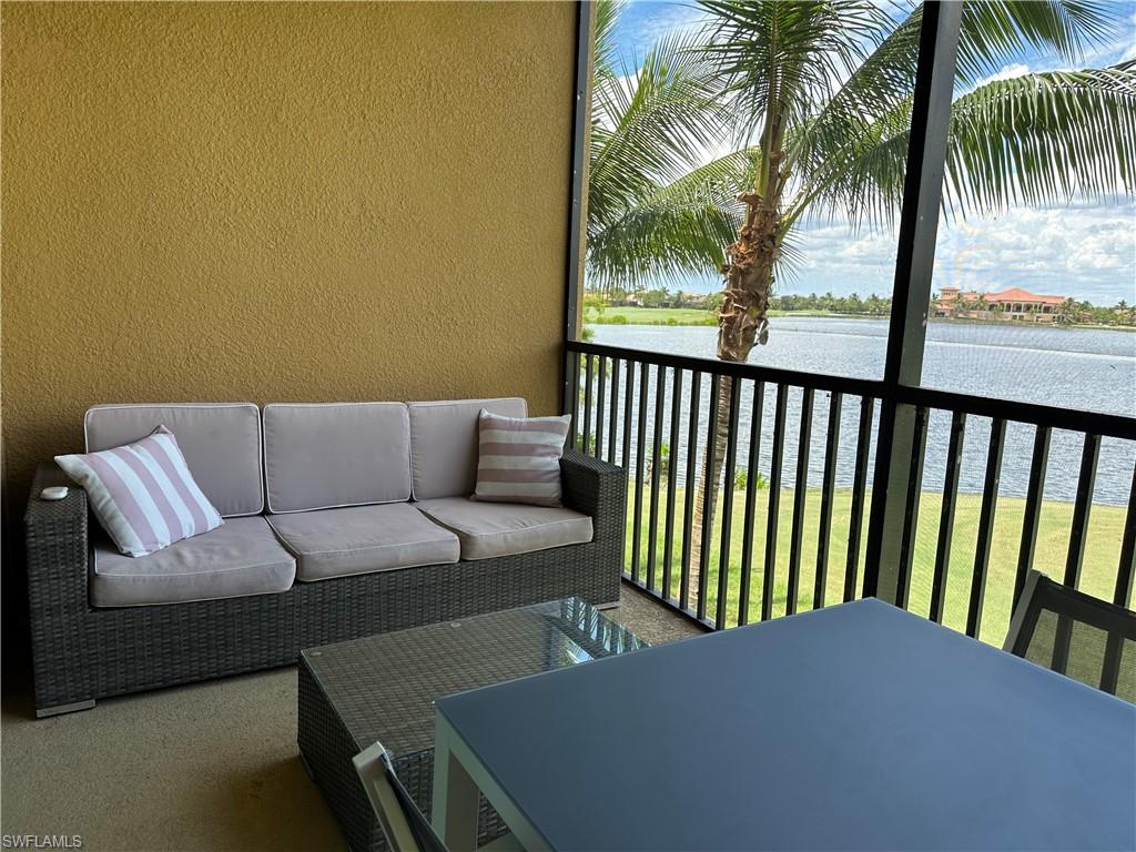 Balcony featuring outdoor lounge area and a water view