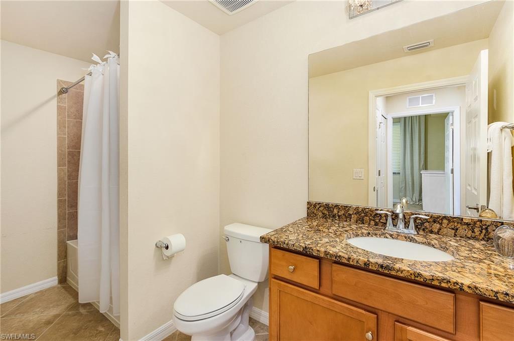 Second bathrm with shower over tub and laundry area.