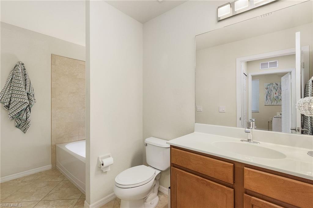 Guest bath with shower over tub and laundry area.