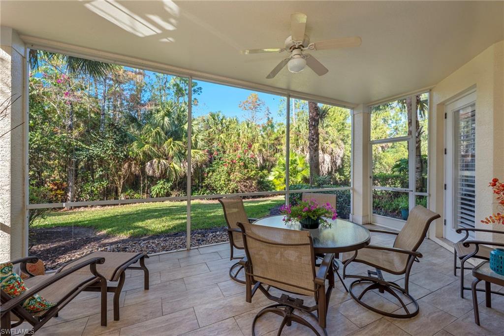 Sunroom / solarium featuring a wall of windows