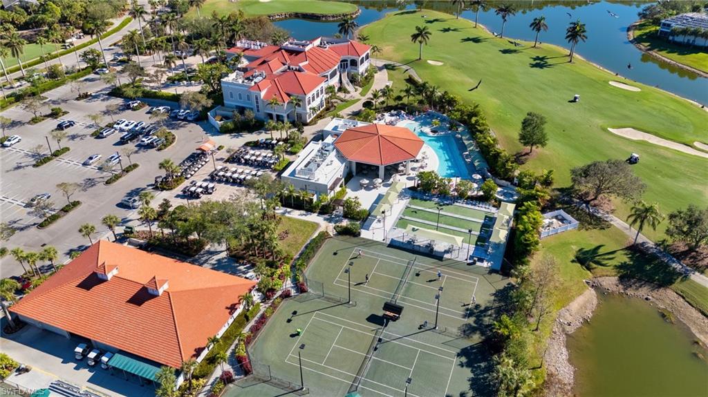 Drone / aerial view of a nearby body of water and a golf club