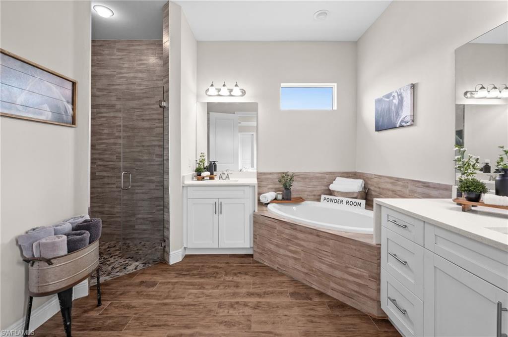 master bathroom with soaking tub and custom cave like walk in shower