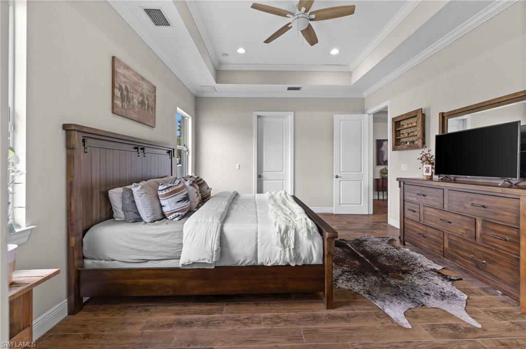 master bedroom with tray ceiling