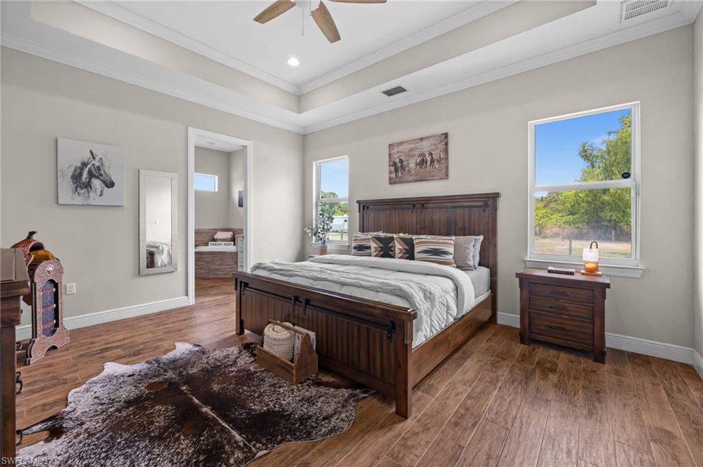 master bedroom with tray ceiling