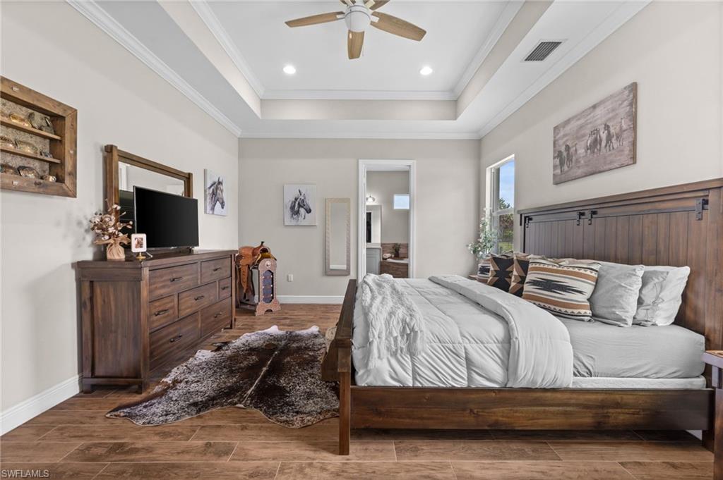 master bedroom with tray ceiling