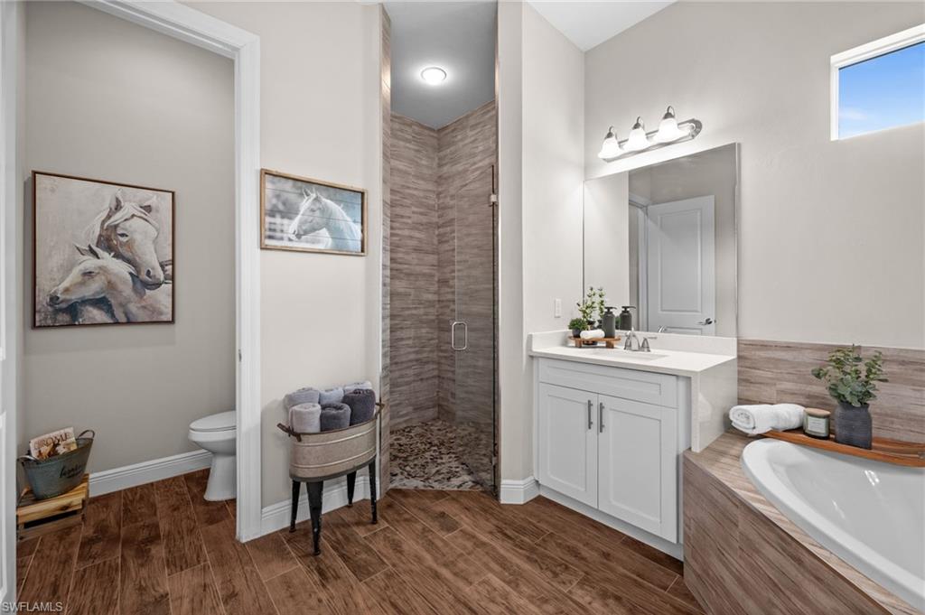 master bathroom with soaking tub and custom cave like walk in shower