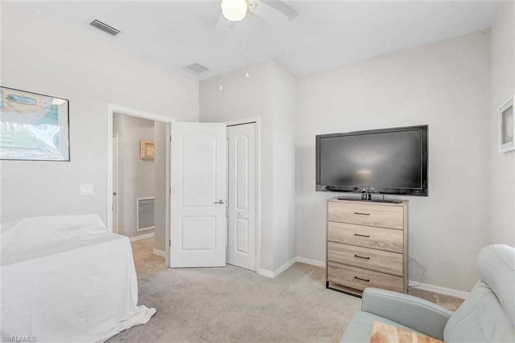Bedroom featuring light carpet and a ceiling fan
