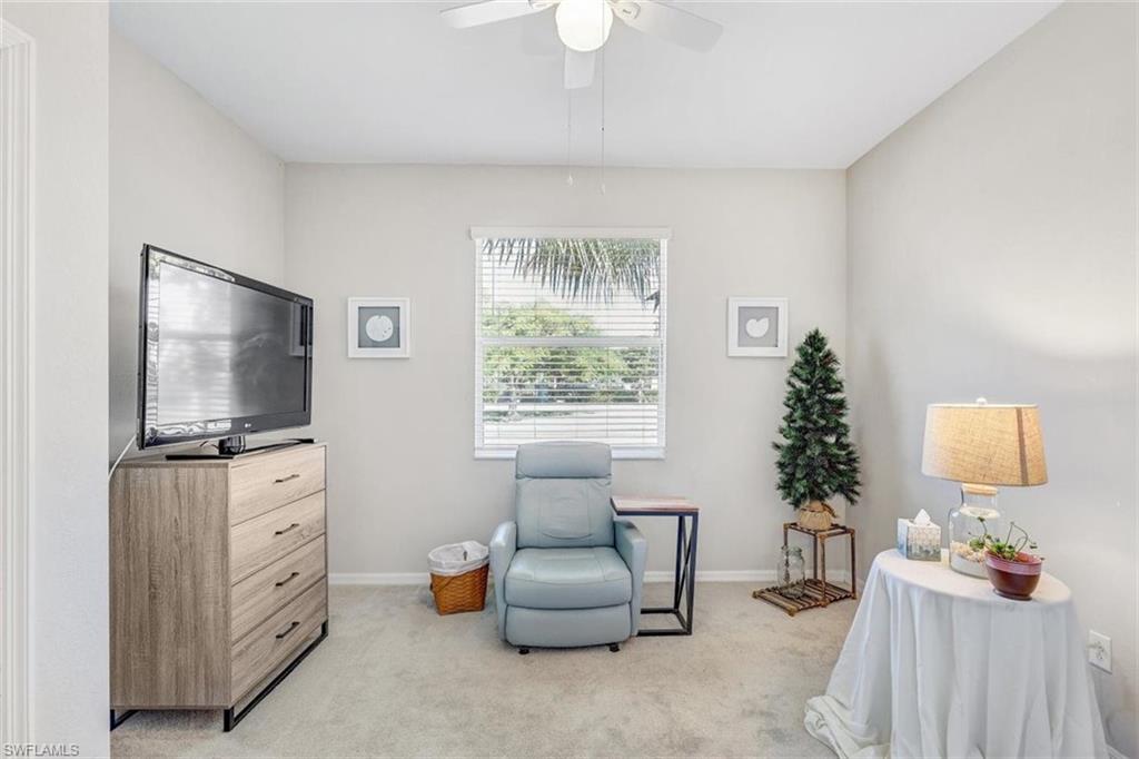 Sitting room with light colored carpet and ceiling fan