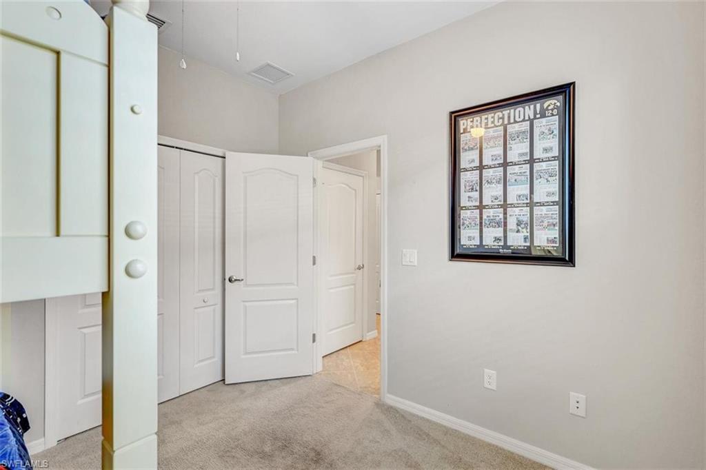 Unfurnished bedroom with a closet and light colored carpet