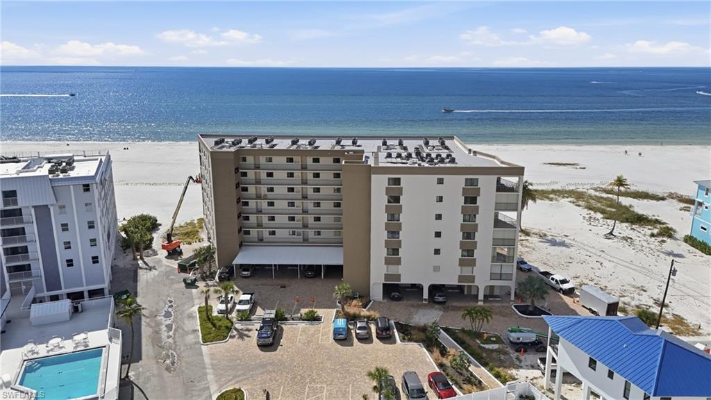 Bird's eye view of apartment complex / building and extended coastline- virtually enhanced