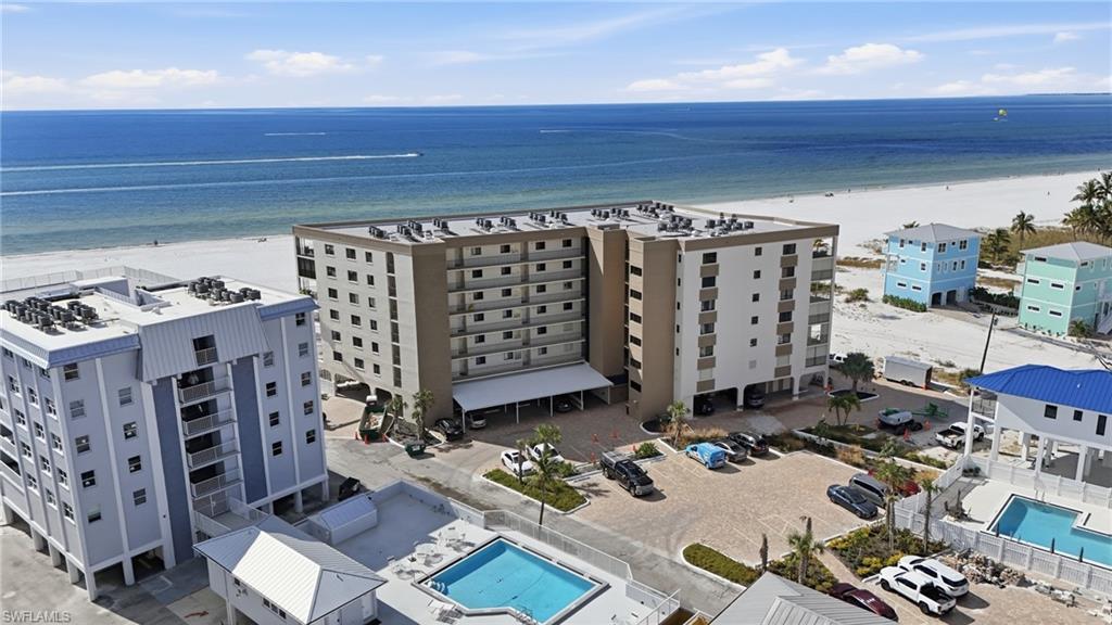 Drone / aerial view of a pool area and apartment complex - virtually enhanced