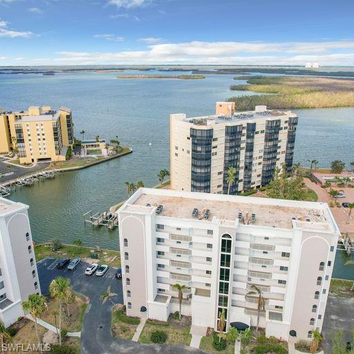 Drone / aerial view of apartment complex and a nearby body of water