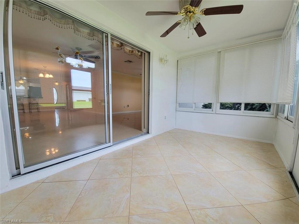 Empty room featuring a ceiling fan and light tile patterned flooring