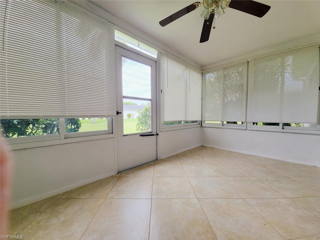Unfurnished sunroom with healthy amount of natural light and tile patterned floors
