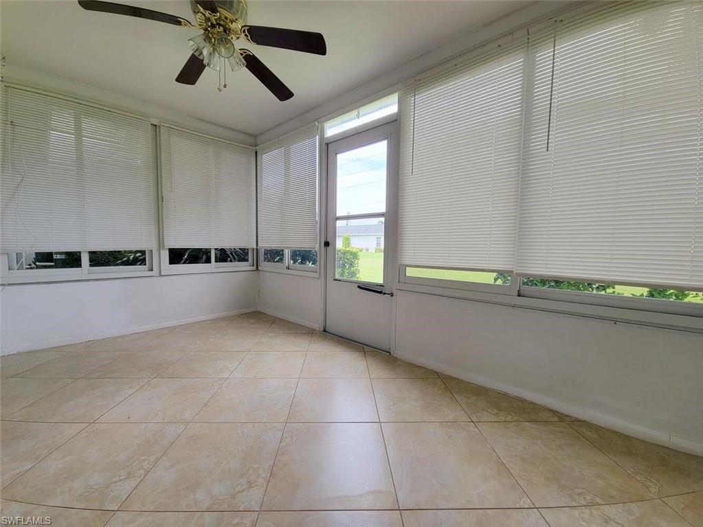 Unfurnished sunroom with tile patterned floors