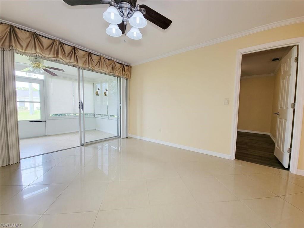 Unfurnished bedroom with crown molding, light tile patterned floors, and ceiling fan