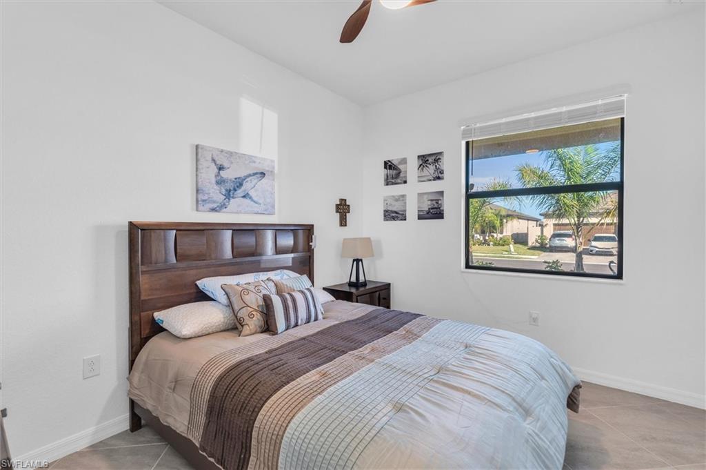 Bedroom featuring light tile patterned floors and ceiling fan