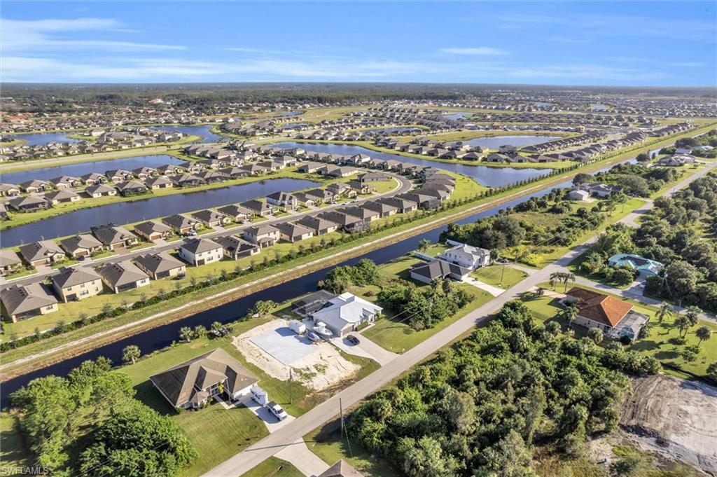 Aerial overview of property's location with a nearby body of water and nearby suburban area