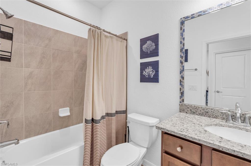 Bathroom with vanity and shower / bath combo with shower curtain