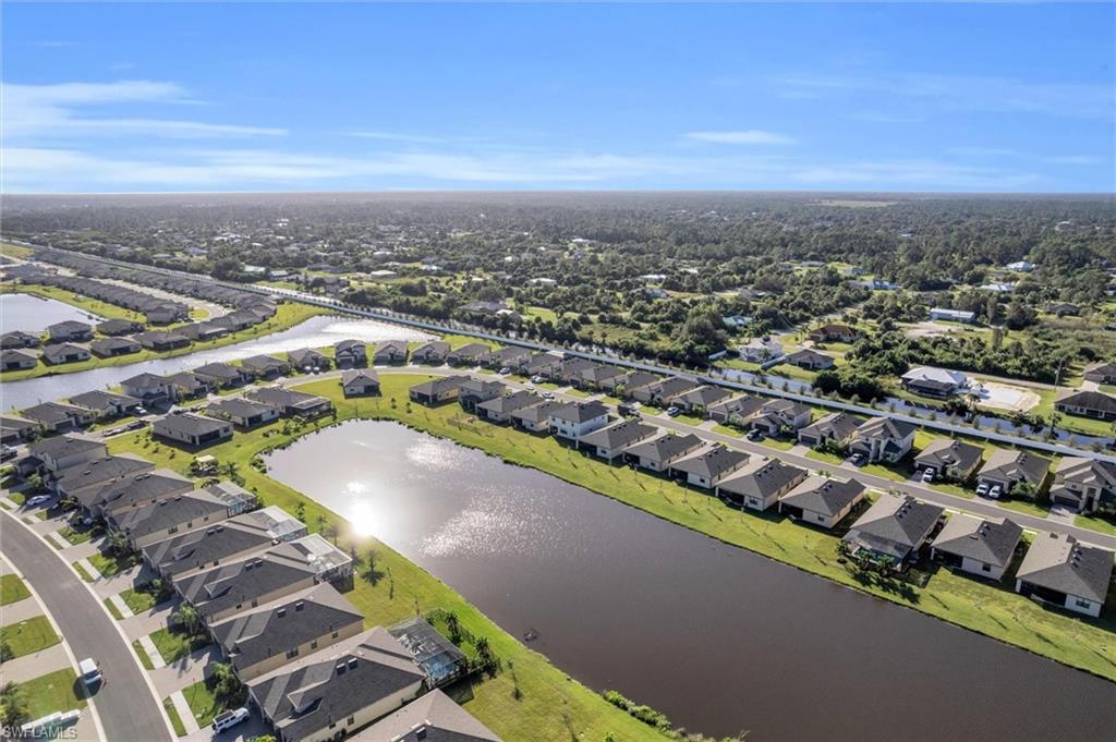 Aerial perspective of suburban area featuring a large body of water
