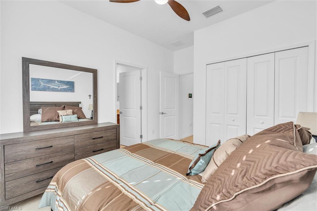 Bedroom with a ceiling fan and a closet