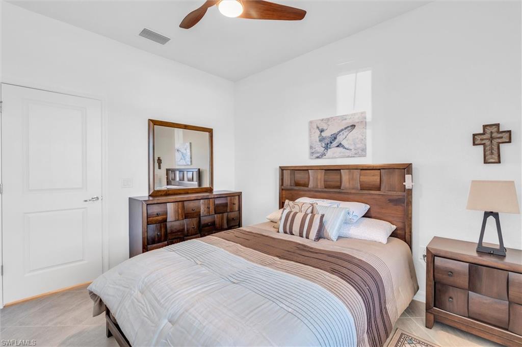 Bedroom with a ceiling fan and light tile patterned floors