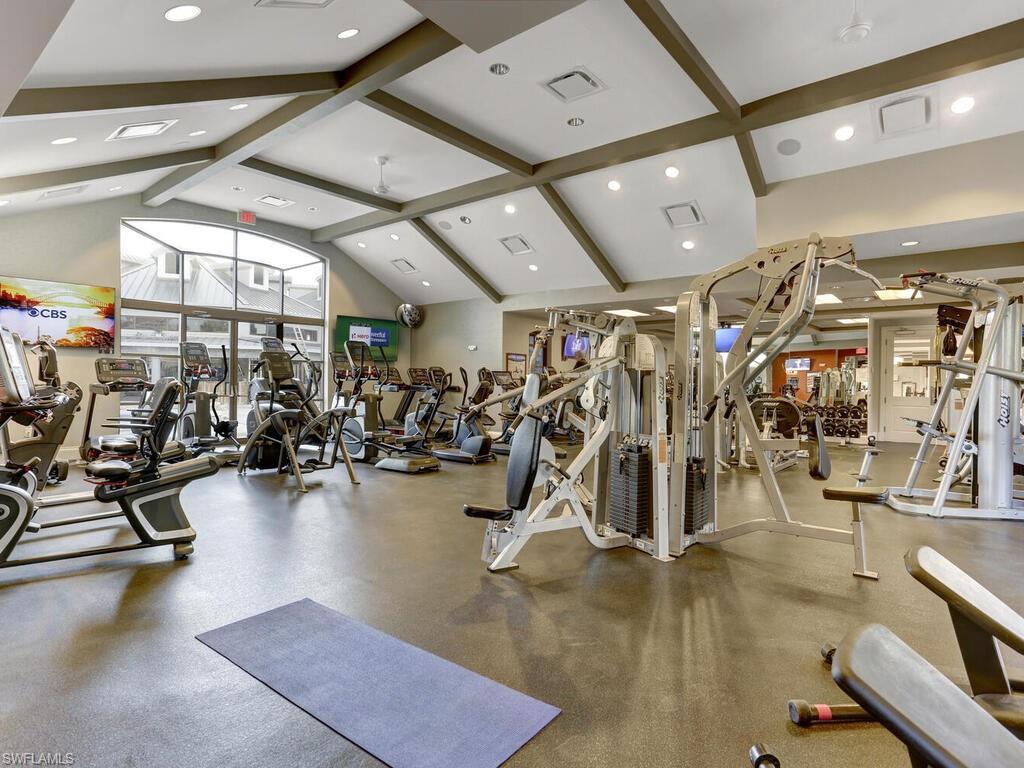 Gym with high vaulted ceiling, beam ceiling, and recessed lighting