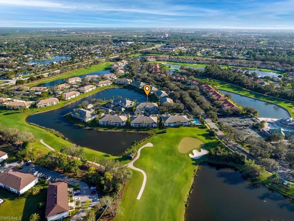 Aerial overview of property's location with a golf club, a nearby body of water, and nearby suburban area