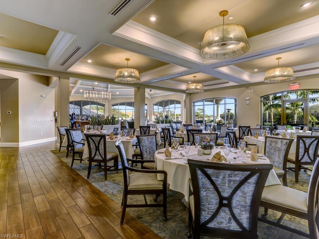 Dining area featuring coffered ceiling, crown molding, a chandelier, wood finished floors, and beam ceiling