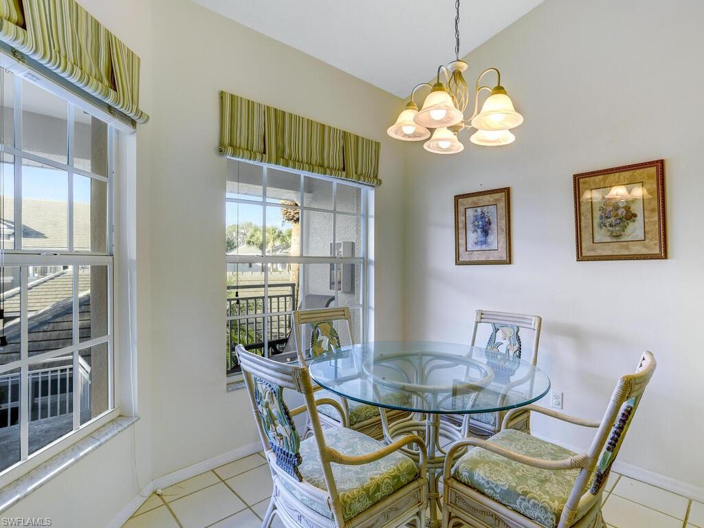 Dining room featuring light tile patterned flooring and a chandelier