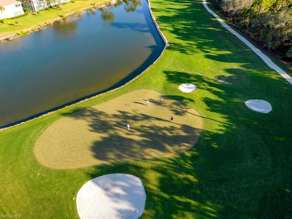 Drone / aerial view of a large body of water and a local golf course