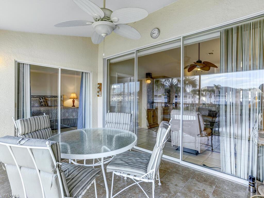 Sunroom featuring a ceiling fan, outdoor dining area, and a patio area