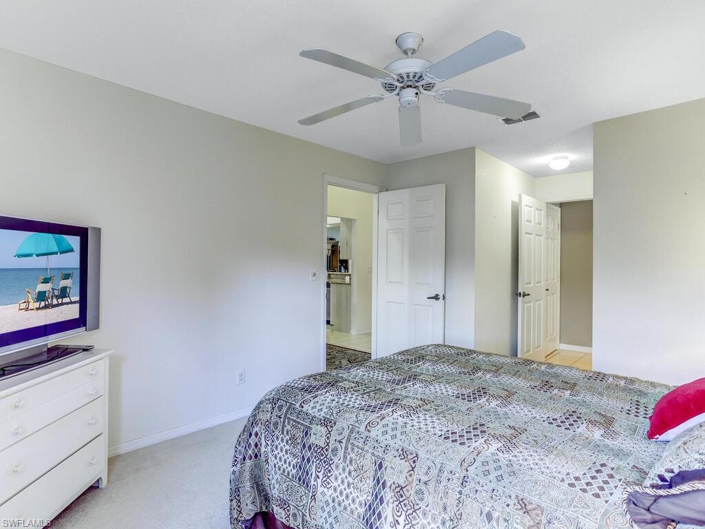 Bedroom featuring light colored carpet and ceiling fan
