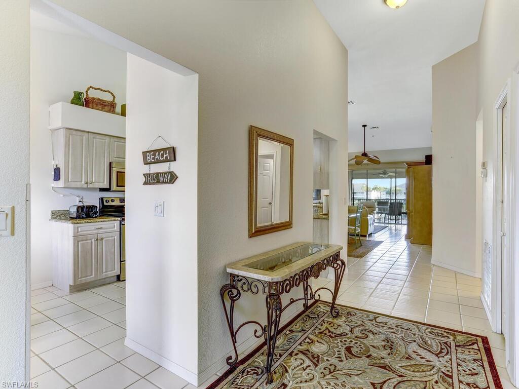 Hallway featuring light tile patterned floors and baseboards