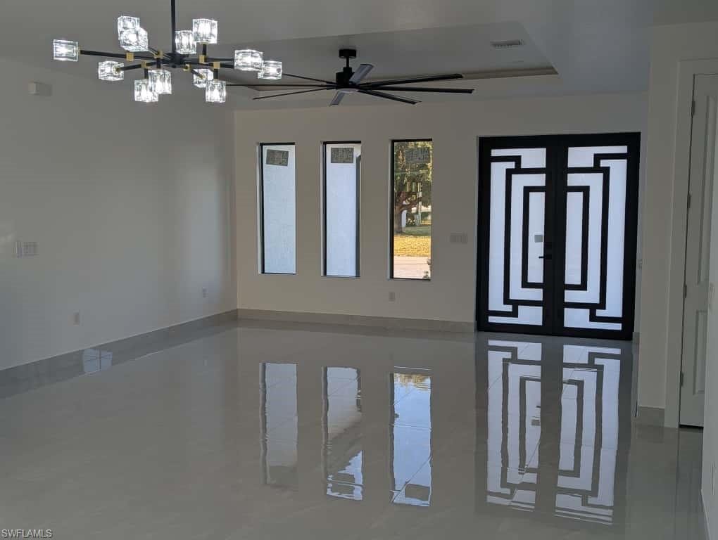 Foyer entrance featuring a chandelier and ceiling fan