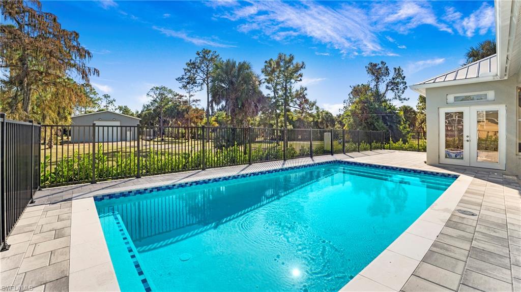 View of pool featuring a patio and french doors