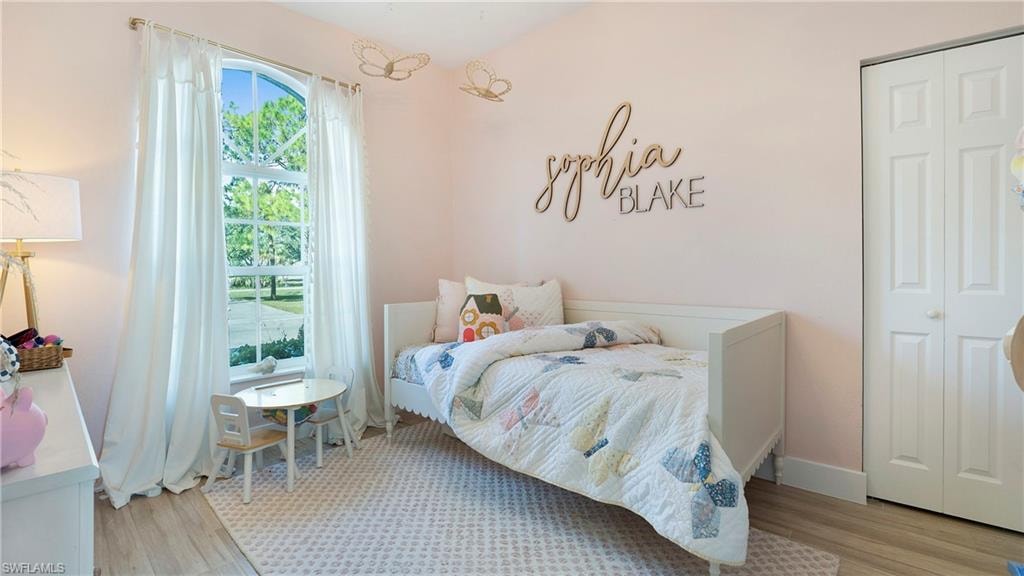 Bedroom featuring light wood-type flooring and a closet