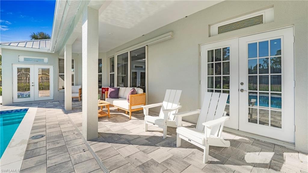 View of patio featuring french doors, an outdoor pool, and an outdoor hangout area