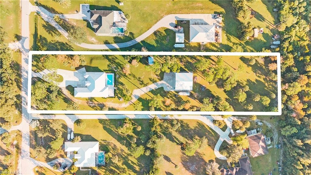 Aerial view of property and surrounding area featuring property parcel outlined