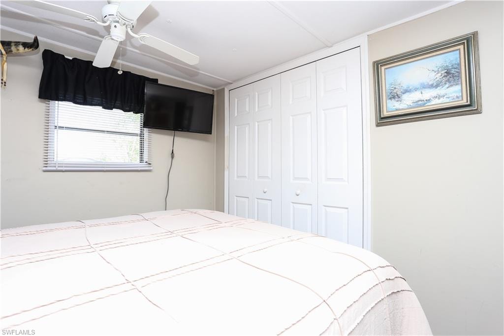 Bedroom featuring ceiling fan and a closet