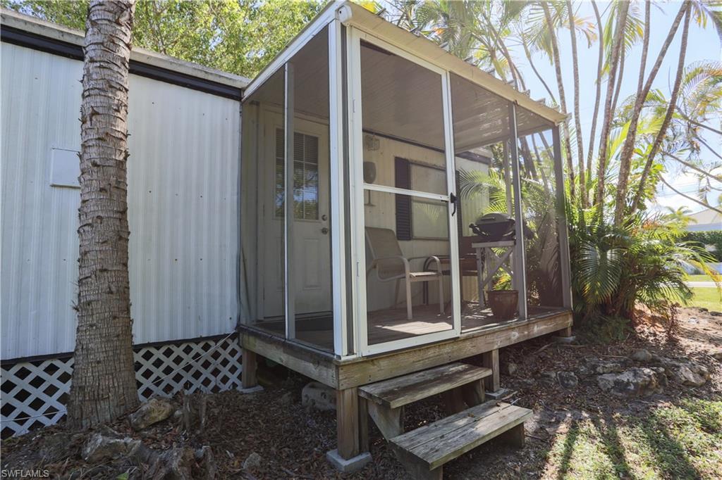 View of outbuilding with a sunroom
