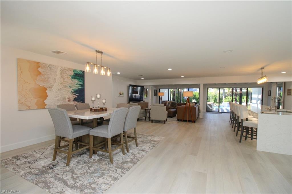 Dining space featuring sink and light wood-type flooring