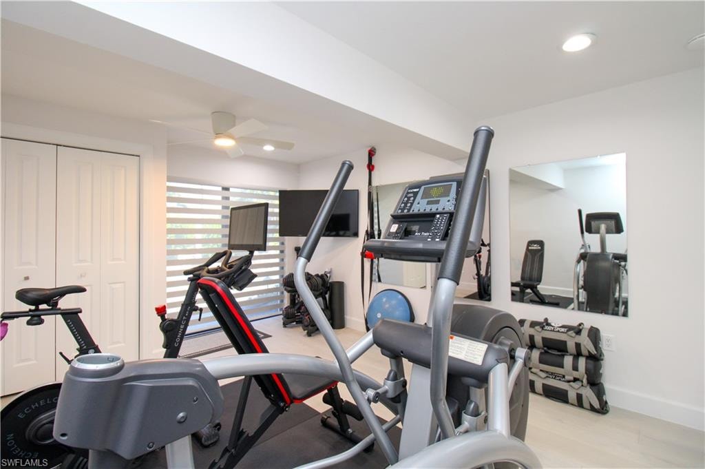 Workout area featuring light hardwood / wood-style floors and ceiling fan