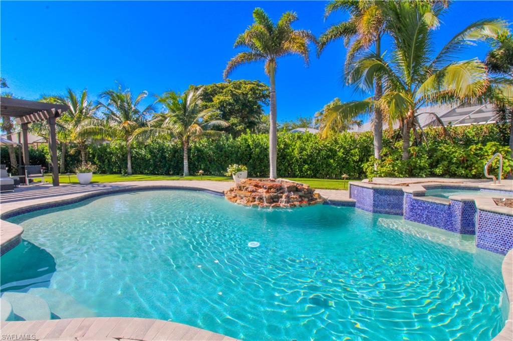 View of pool with a patio area and an in ground hot tub
