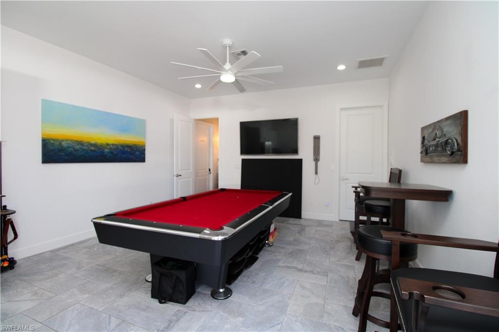 Playroom with ceiling fan and billiards