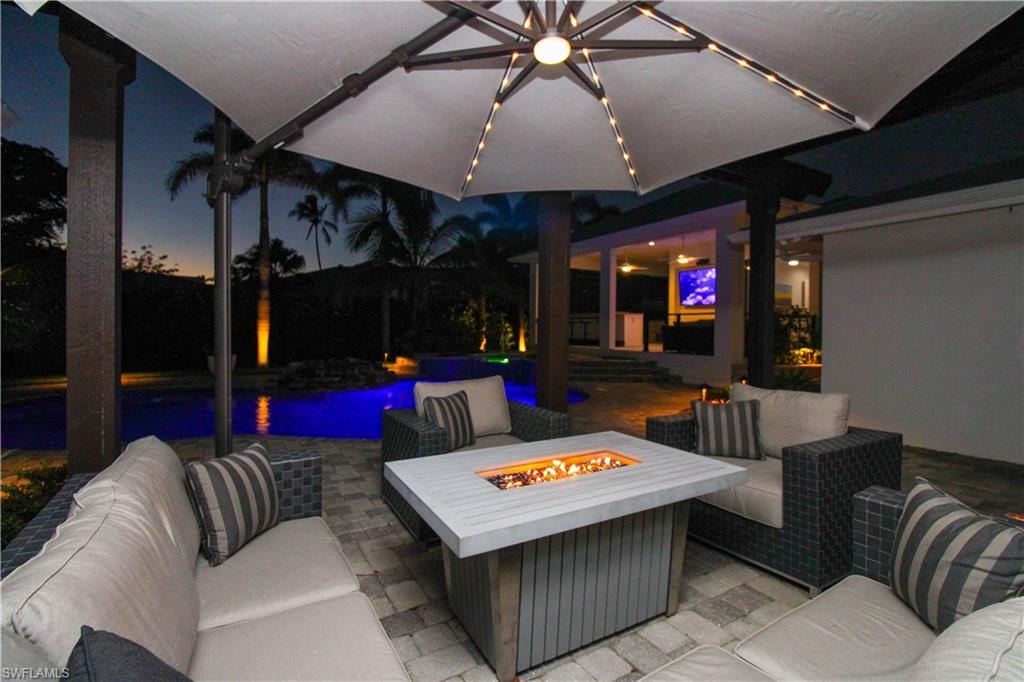 Patio terrace at dusk featuring an outdoor living space with a fire pit