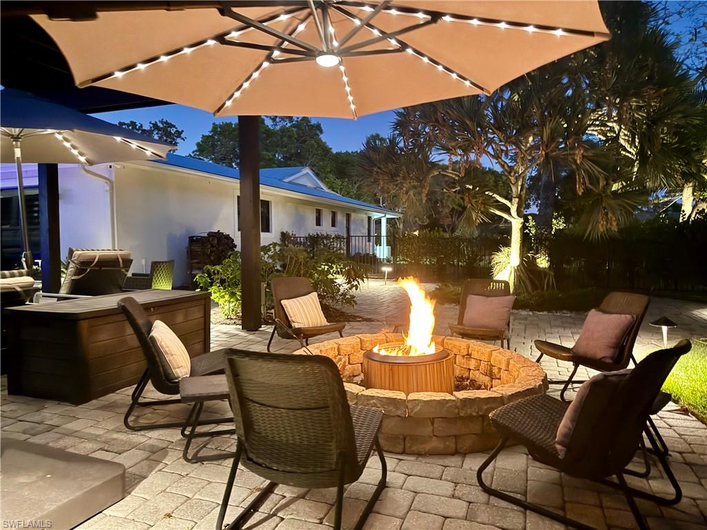 View of patio featuring an outdoor fire pit