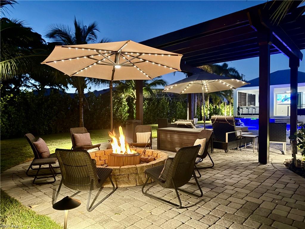 View of patio featuring an outdoor living space with a fire pit